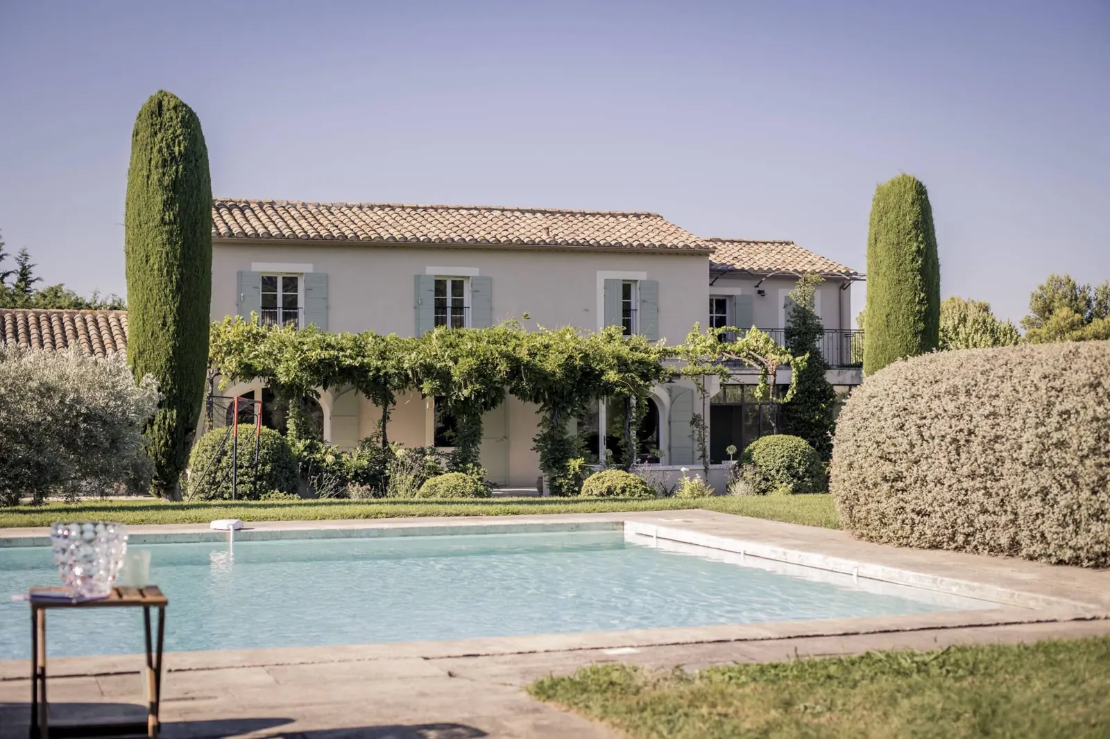 Mas Domitia, its wisteria-covered facade and pool in Saint-Rémy-de-Provence